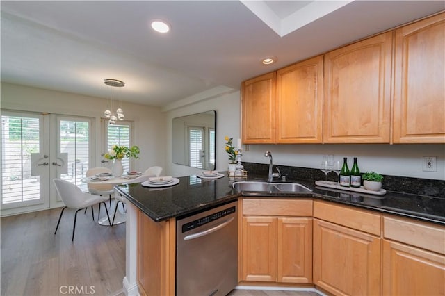 kitchen featuring french doors, sink, hanging light fixtures, light hardwood / wood-style flooring, and stainless steel dishwasher