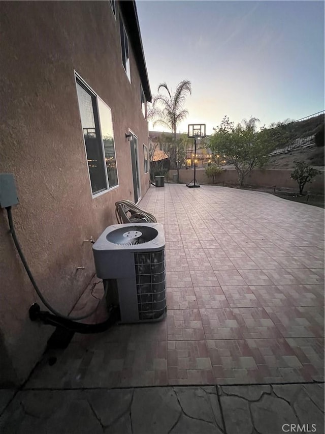 patio terrace at dusk with central AC unit