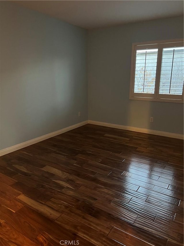 empty room with dark wood-type flooring