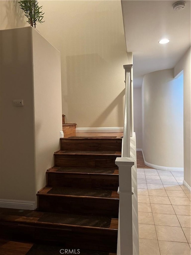 stairs featuring tile patterned floors