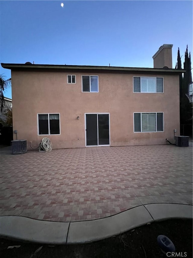 rear view of house with a patio area and central air condition unit