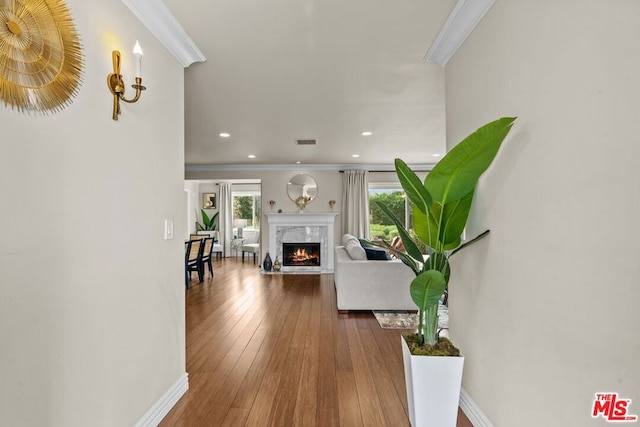 hall featuring hardwood / wood-style floors and ornamental molding