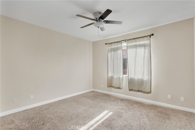 carpeted spare room featuring ceiling fan