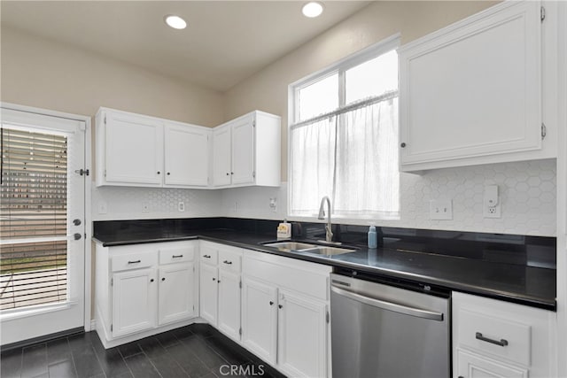 kitchen with tasteful backsplash, sink, white cabinets, and stainless steel dishwasher