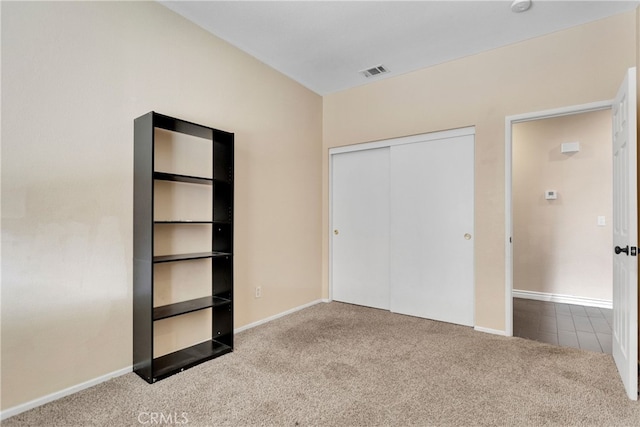 unfurnished bedroom with a closet and carpet