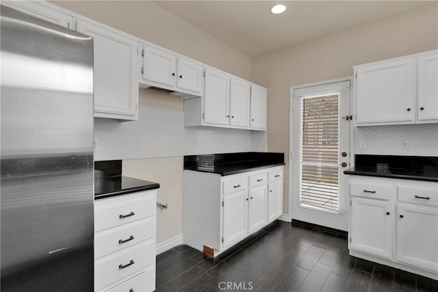 kitchen featuring white cabinets, dark hardwood / wood-style floors, and stainless steel fridge