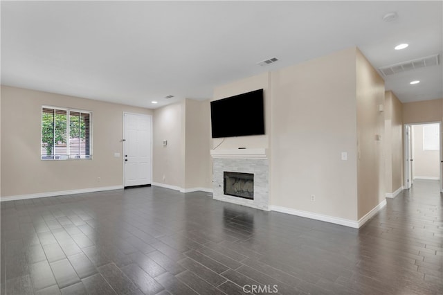 unfurnished living room featuring dark wood-type flooring