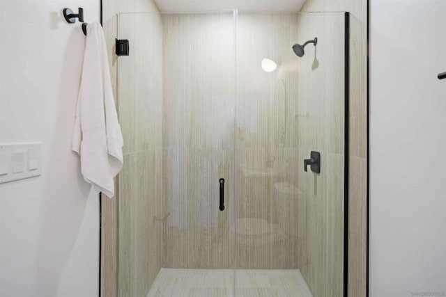 bathroom with a shower with door