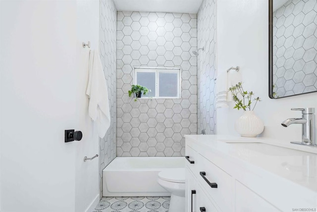 full bathroom with vanity, tiled shower / bath, and toilet