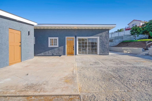 rear view of property featuring a patio