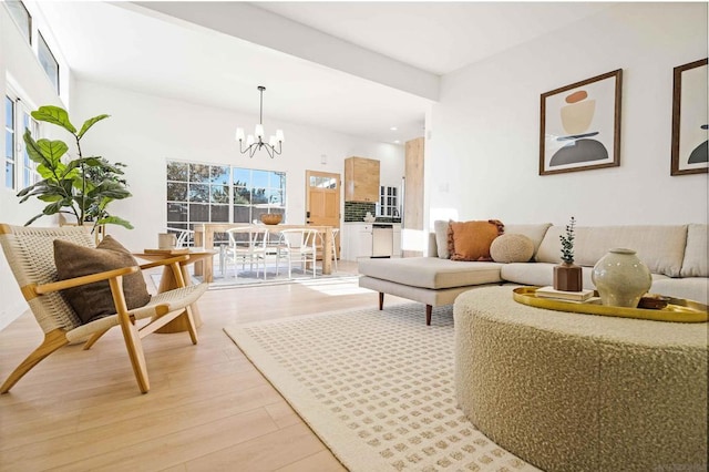 living room with a notable chandelier and light wood-type flooring