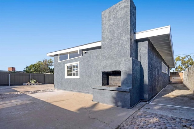 rear view of property featuring a patio area