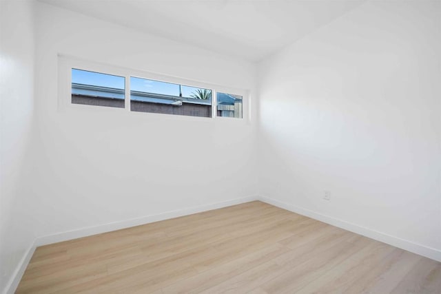 empty room with light hardwood / wood-style flooring