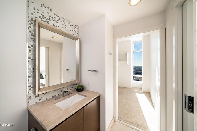 bathroom featuring backsplash, tile patterned floors, and vanity