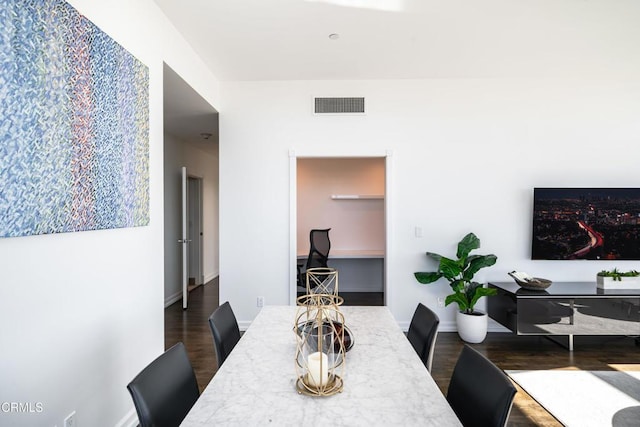 dining area featuring dark wood-type flooring