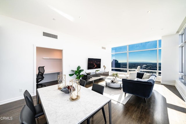 living room with hardwood / wood-style flooring and a wall of windows