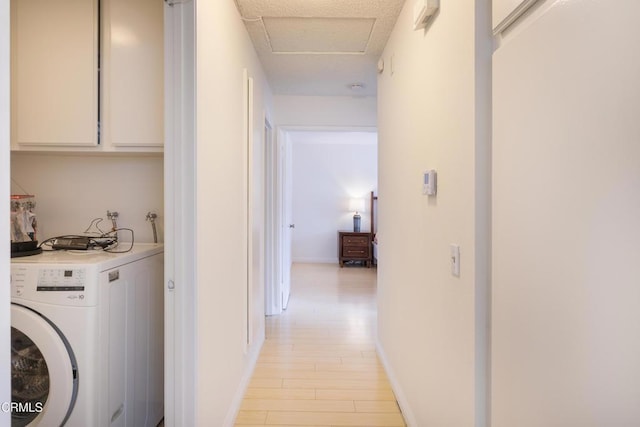 corridor featuring washer / dryer and light hardwood / wood-style flooring