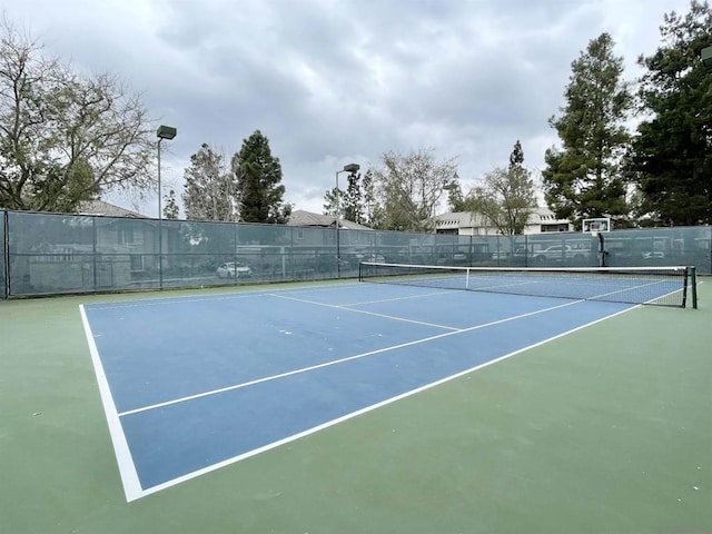 view of sport court with basketball hoop