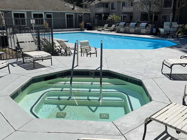 view of pool featuring a hot tub