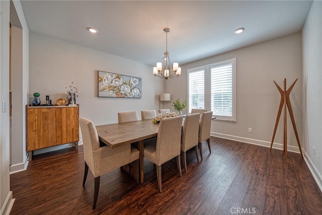 dining room with an inviting chandelier and dark wood-type flooring