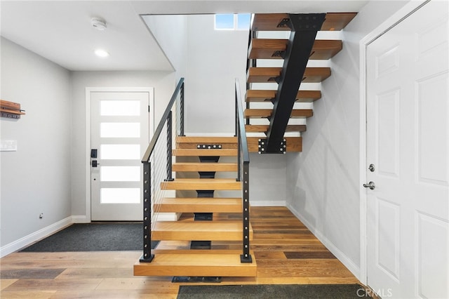 entrance foyer with hardwood / wood-style floors and a healthy amount of sunlight