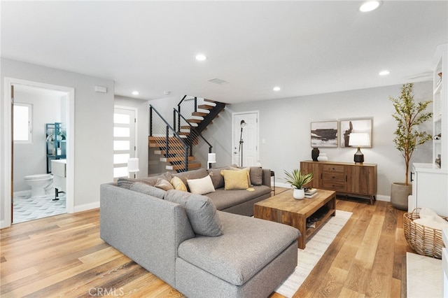 living room with light hardwood / wood-style floors and a wealth of natural light