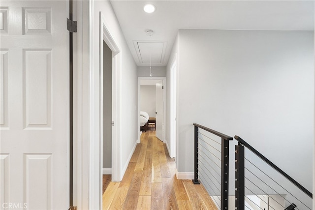 hallway with light hardwood / wood-style floors