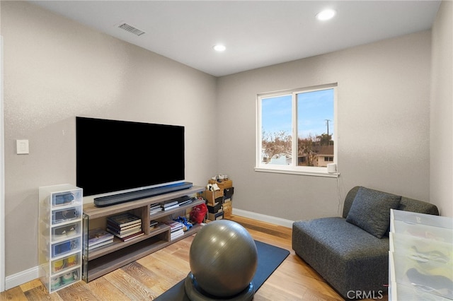 exercise area featuring hardwood / wood-style flooring