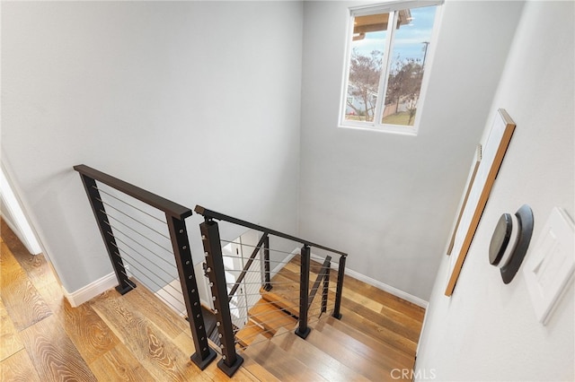 stairs with hardwood / wood-style floors