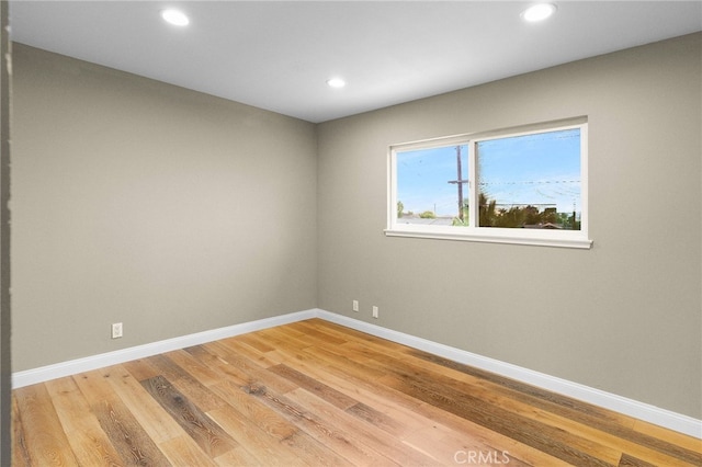 spare room with hardwood / wood-style floors