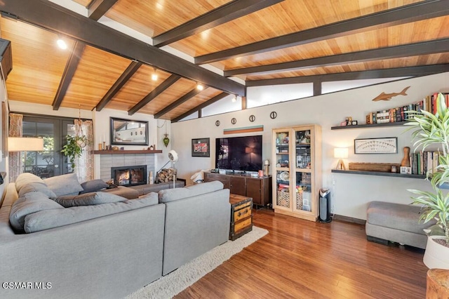 living room with hardwood / wood-style floors, lofted ceiling with beams, wooden ceiling, and a fireplace