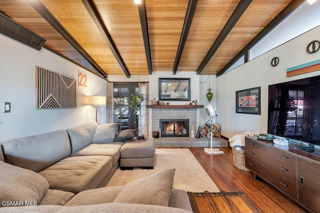 living room featuring a fireplace, hardwood / wood-style floors, vaulted ceiling with beams, and wood ceiling