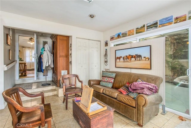 living area featuring plenty of natural light, ceiling fan, and light tile patterned floors