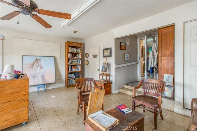 sitting room with ceiling fan and light tile patterned floors