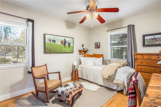 bedroom with hardwood / wood-style flooring and ceiling fan