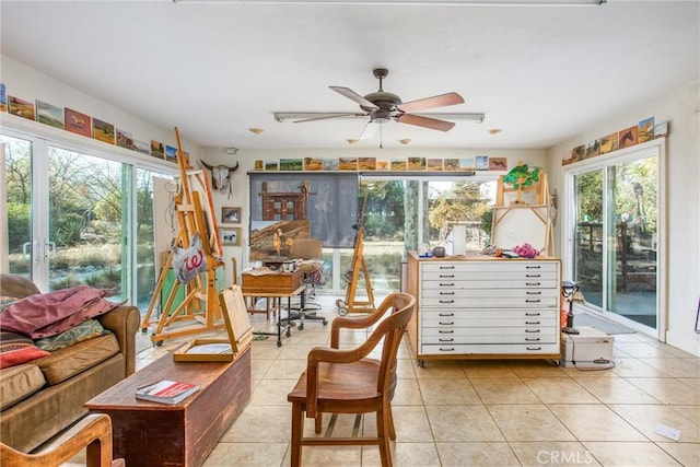 sunroom / solarium featuring ceiling fan