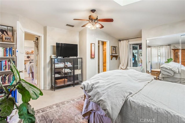 carpeted bedroom with ceiling fan and vaulted ceiling