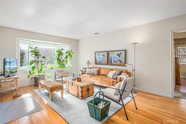 living room with a healthy amount of sunlight and light wood-type flooring