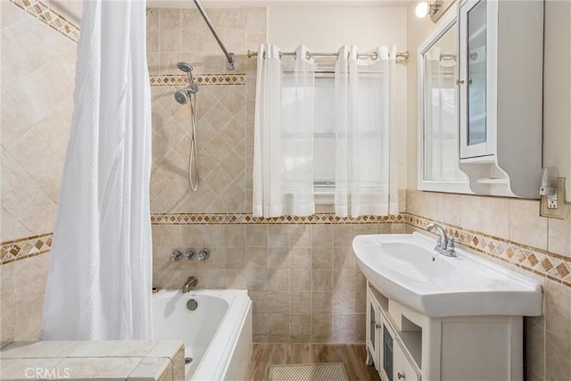 bathroom featuring vanity, tile walls, and shower / tub combo with curtain