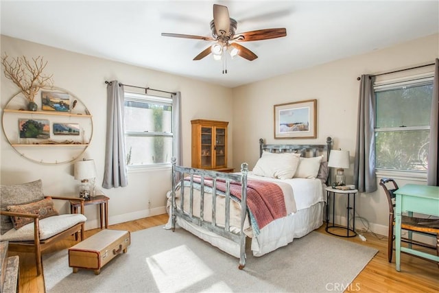 bedroom featuring ceiling fan and light hardwood / wood-style flooring