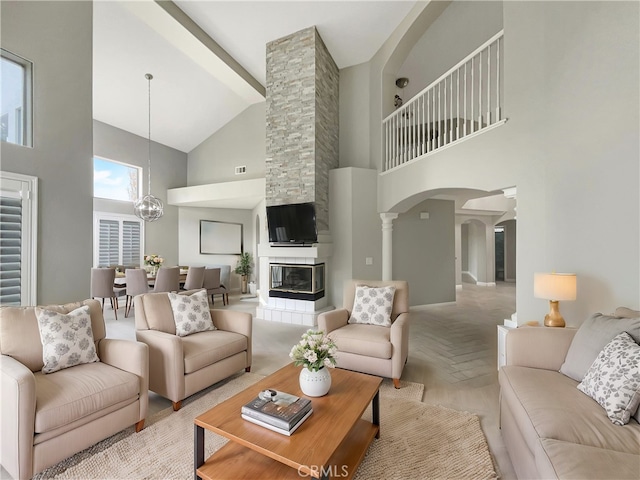 living room with light parquet flooring, an inviting chandelier, and a fireplace