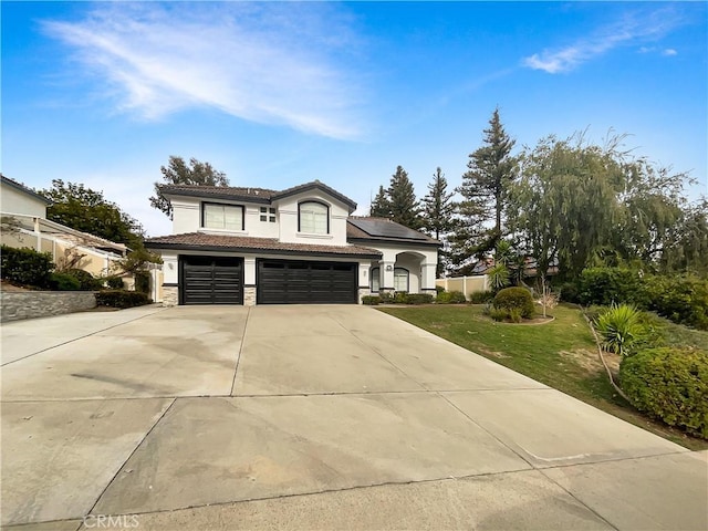 view of front of home with a garage and a front lawn