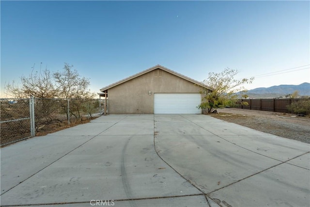 view of side of home featuring a mountain view and a garage