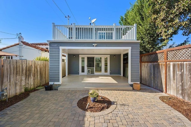 back of house with a patio area and a balcony