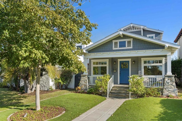 craftsman-style home with a porch and a front lawn