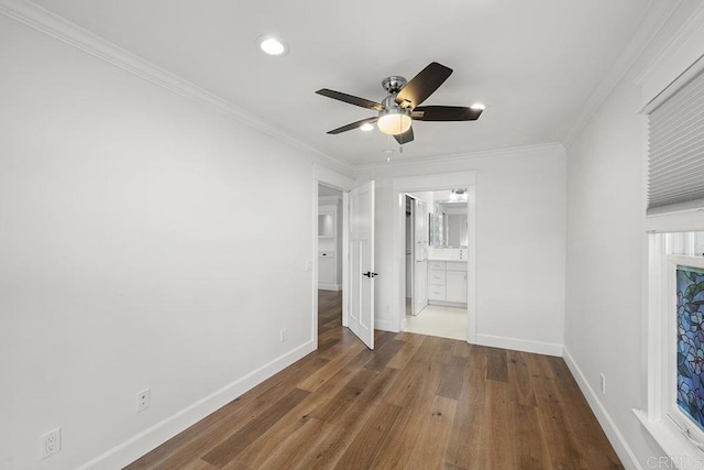 unfurnished bedroom with connected bathroom, ceiling fan, crown molding, and dark hardwood / wood-style floors