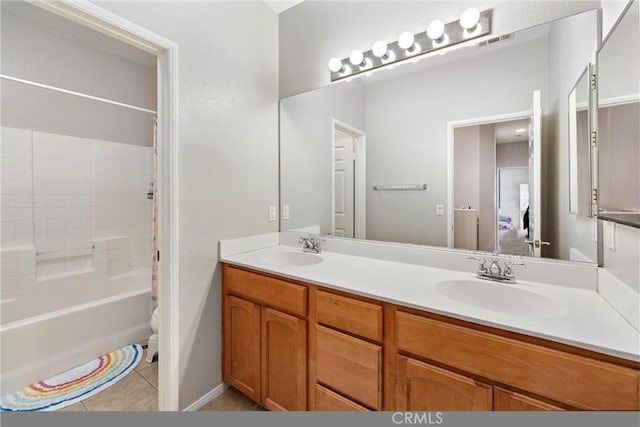 full bathroom with double vanity, tile patterned flooring, and bathtub / shower combination