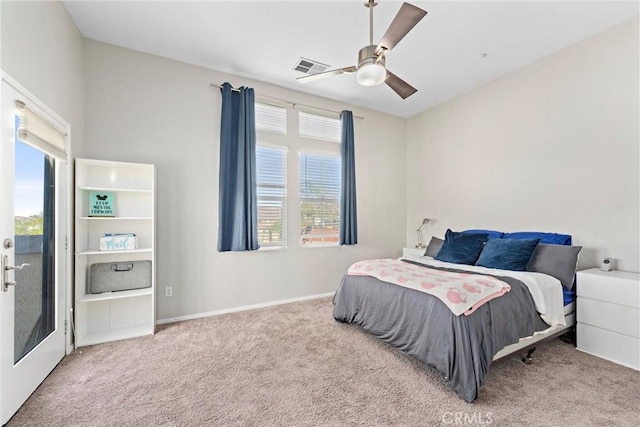 carpeted bedroom with multiple windows and a ceiling fan