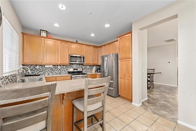 kitchen with stainless steel appliances, tasteful backsplash, a peninsula, light tile patterned floors, and recessed lighting