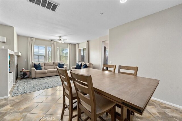 dining room with baseboards and a ceiling fan